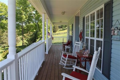 You will love sitting on the front of this porch looking out at gorgeous countryside!