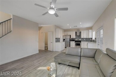 Living area with light wood finished floors, a cei