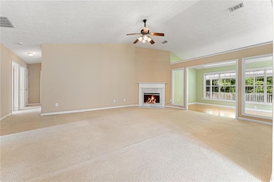 Unfurnished living room with ceiling fan, visible 