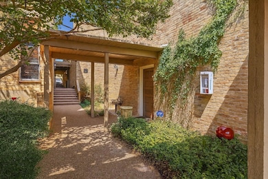 Entrance to property featuring brick siding