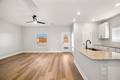 This spacious, open living area is filled with natural light, creating a warm and inviting atmosphere.