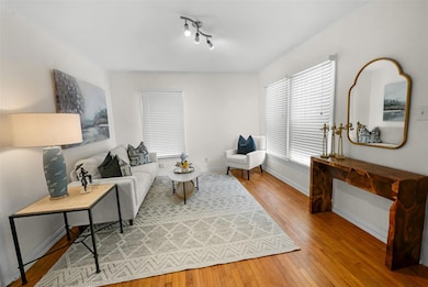 Living area featuring light wood-style floors and baseboards