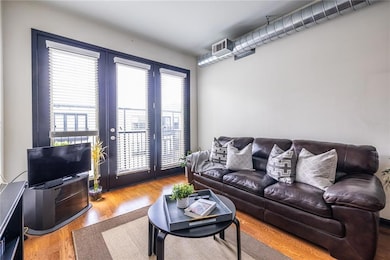 The living area is full of natural light and featu