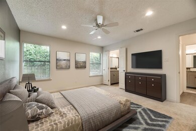 Bedroom with a textured ceiling, light colored car