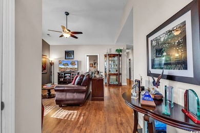 Living room with hardwood / wood-style flooring an