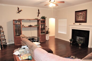 Den with wood floors...