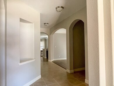 Hallway featuring tile flooring and arched walkways