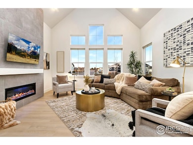 Gather friends and loved ones in this lovely space. Stunning fireplace wall extends to the ceiling. Programmable electric fireplace