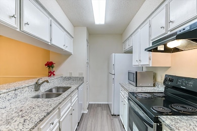 Kitchen featuring electric range, stainless steel