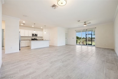 Unfurnished living room featuring crown molding, a