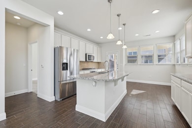 Kitchen with stainless steel appliances, a sink, 