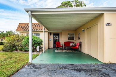 Front of villa with attached carport and storage closet