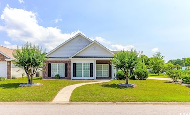View of front facade featuring a front lawn and brick siding