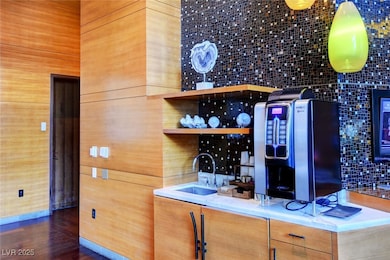 Bar featuring a sink and wood finished floors