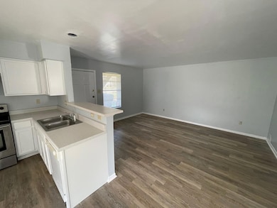 Kitchen with stainless steel electric range oven,