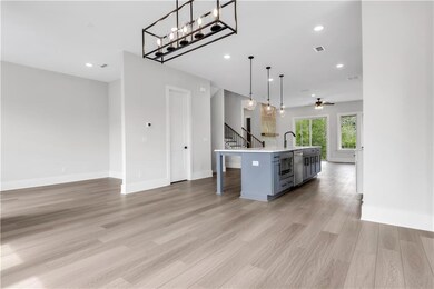 Kitchen with light wood-style flooring, a sink, li