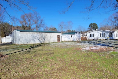 Back of property featuring fence and a lawn