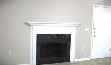 Interior details featuring a fireplace and baseboa