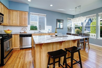 Updated with slab granite & subway backsplash, this light & bright Kitchen boasts tons of counter & cabinet space.
