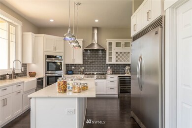 Kitchen view with lots of light,high ceilings,lots of large cabinets,second fride cooler under cabinets and low maintenance hardwood flooring through out main level