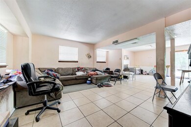 Tiled living room with a textured ceiling