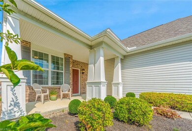 An eye-catching exterior features brick, vinyl & s