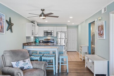 Kitchen featuring glass insert cabinets, dark wood-type flooring, stainless steel appliances, ceiling fan, and crown molding