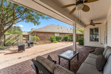 Quick sneak-peak to the large back paver area with covered patio and fans.