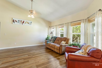 Living room featuring lofted ceiling and wood finished floors