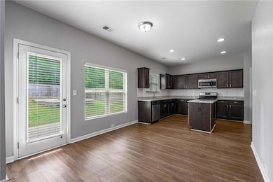Kitchen featuring stainless steel appliances, dark
