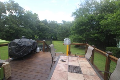 deck overlooking spacious back yard