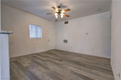Spare room featuring wood finished floors, a ceili