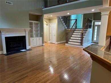 Unfurnished living room with ornate columns, a tow