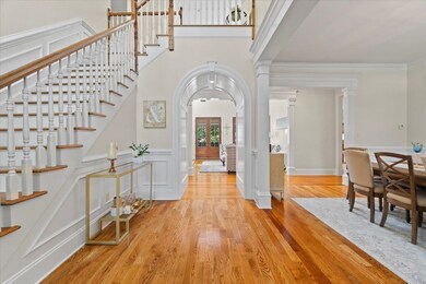 Foyer featuring ornate columns, light hardwood / w