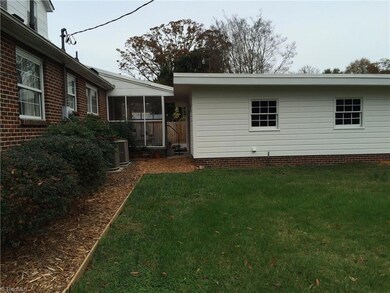 Back exterior with screened porch and back side of attached carport utility room