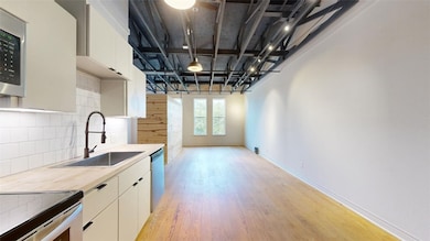 Kitchen featuring decorative backsplash, appliance