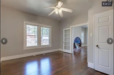 Empty room with dark wood-type flooring, french d