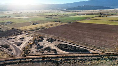 Aerial view of property's location with a mountain backdrop and rural landscape