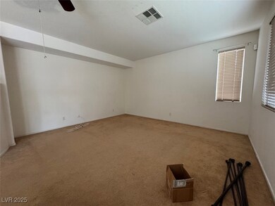 Carpeted spare room with ceiling fan and baseboards
