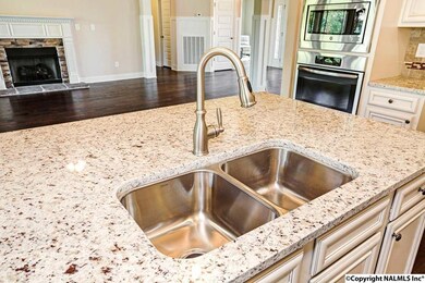 Don't miss out on all the fun! With this oversized kitchen island you can be busy in the kitchen and still part of what's going on the great room.  Such a great open plan!