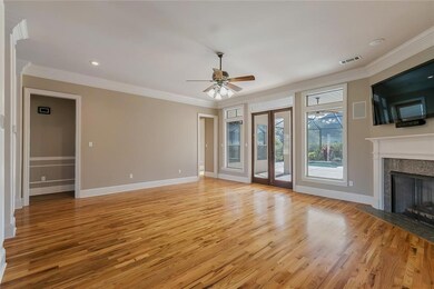 living room with fireplace overlooking pool