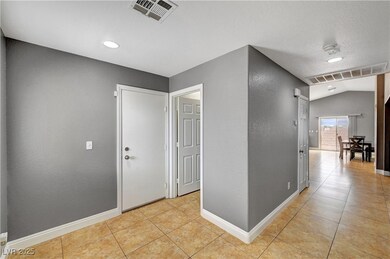 Corridor featuring baseboards, visible vents, and