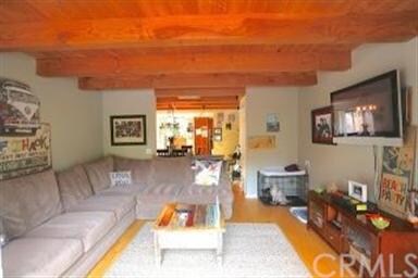 Spacious living room with beautiful wood beamed ce