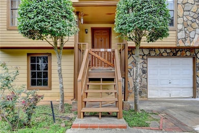 Doorway to property with an attached garage and st