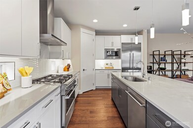 Chefs kitchen with oversized Quartz Island, Huntwood sleek cabinetry, Fisher & Paykel appliances and walk-in pantry.