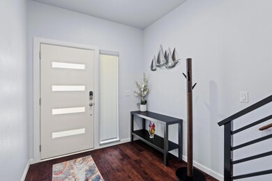 Foyer featuring wood-type flooring and baseboards