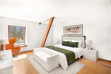 Main level spacious bedroom with a wall of closets