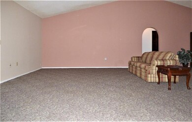 Living room from south wall. Entry to hall for fam