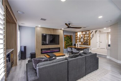 The living room showcases a custom wood-accent wal