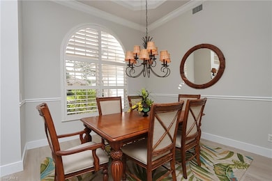 Dining area featuring ornamental molding, light ha